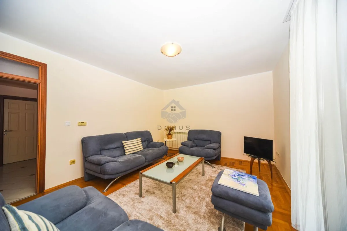 Living room with sofa seating, a coffee table, and a TV.
