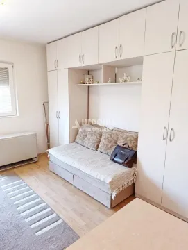 Bedroom with a bed and built-in wardrobes. - image 8