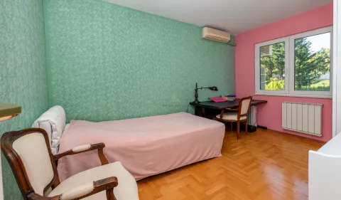 Bedroom with a bed, desk, and a window. - image 8
