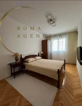 Furnished bedroom with a double bed, wardrobe, and parquet flooring. - image 5