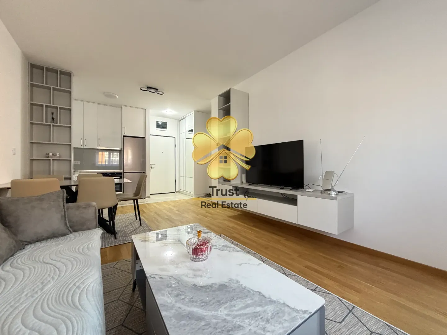 Living room connected to the dining area and kitchen in a modern apartment.