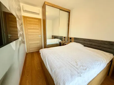Modern bedroom with a double bed and a built-in mirrored wardrobe. - image 11