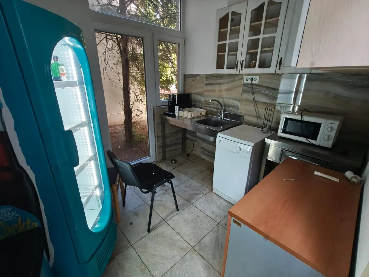 Small kitchen with a sink, cabinetry, and built-in appliances.