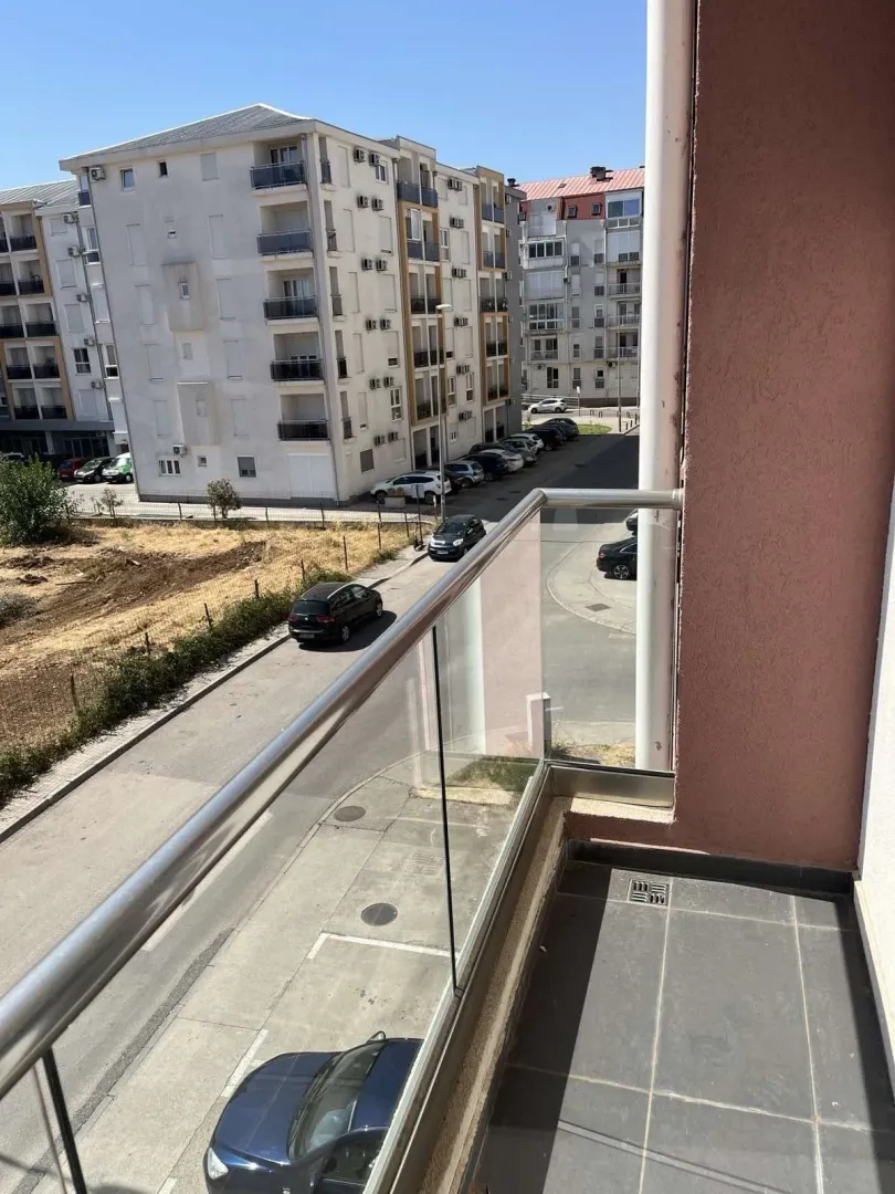 View from the balcony showing the street and surrounding buildings.