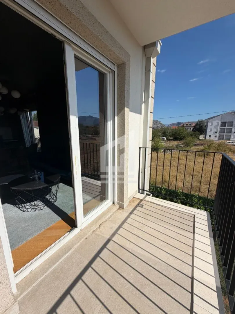 Balcony with metal railing and a view of the surroundings.