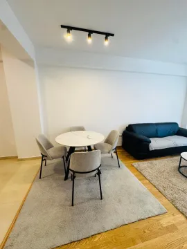 Living room with a dining table and chairs. - image 2
