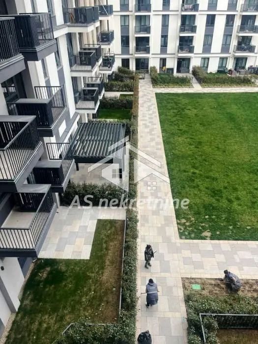 Aerial view of the courtyard and facade of the residential building.