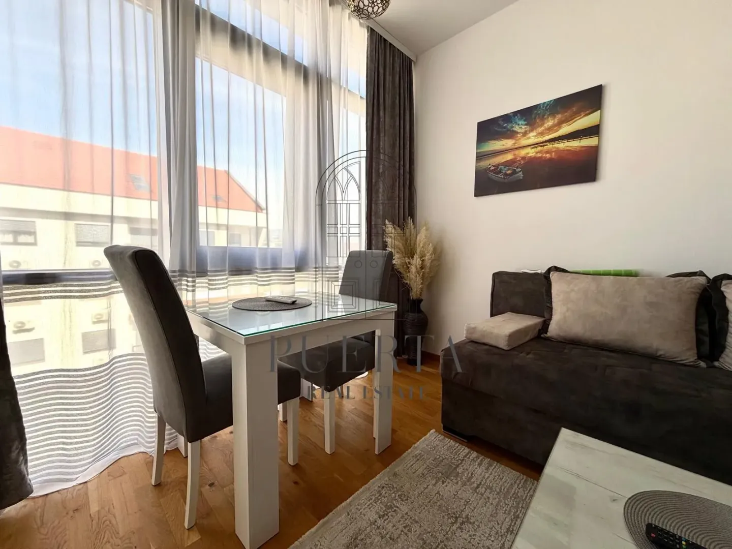 Living room with dining table and sofa set.