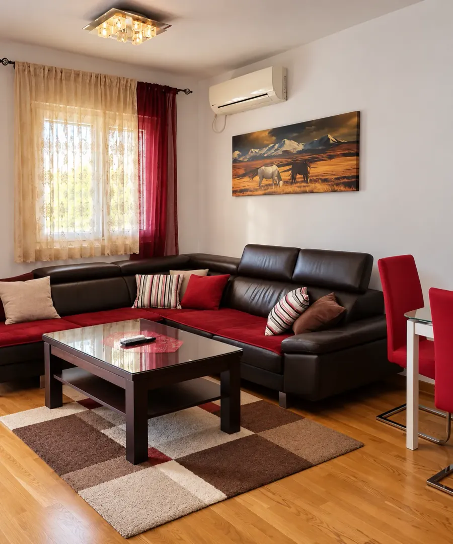 Comfortable living room with a sectional sofa, coffee table, and a window.