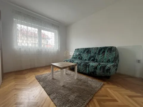 Living room with a sofa, coffee table, and parquet flooring. - image 11