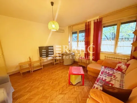 Living room with a sofa and parquet flooring. - image 4