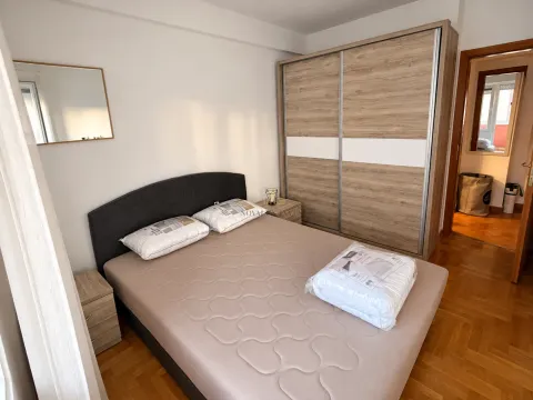 Bedroom featuring a double bed, a large wardrobe, and bedside tables. - image 5