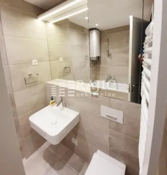 Modernly equipped bathroom with a washbasin and a mirror. - image 10