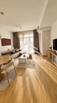 Living room with sofa, dining table and parquet flooring. - image 2