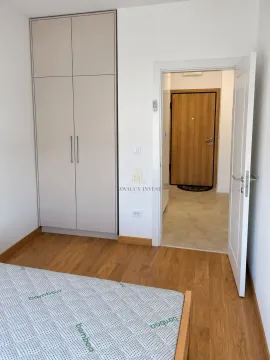 Bedroom with a built-in wardrobe and a view of the hallway and entrance door. - image 5