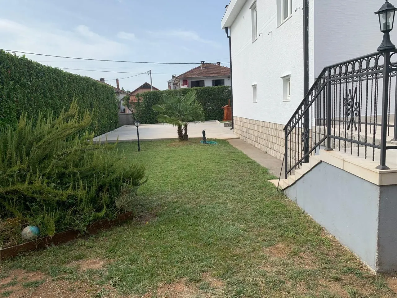 Maintained house yard with a lawn and fence.