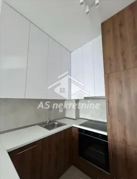 Modern fitted kitchen with white and wood-grain cabinets. - image 7