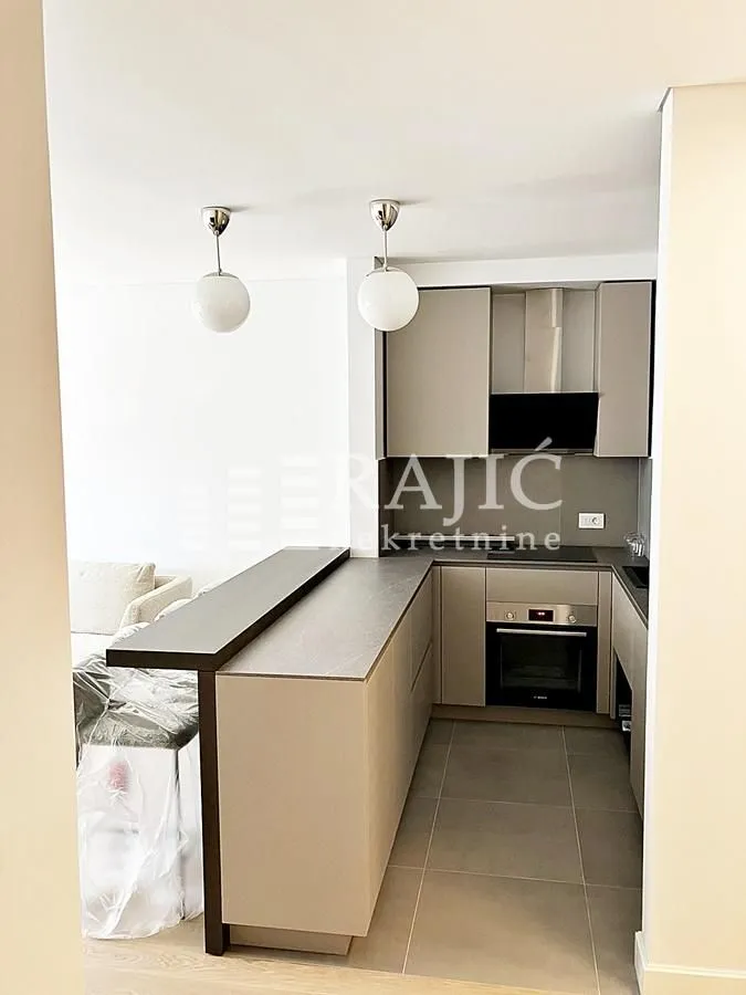 Modern kitchen with a breakfast bar connected to the living room.