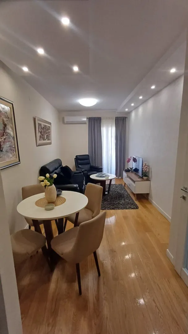 Living room with a dining area, seating set, and TV cabinet.