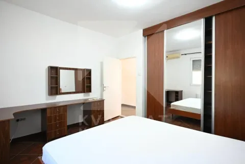 Bedroom featuring a large double bed, a wooden wardrobe with a mirrored door, and a desk. - image 16