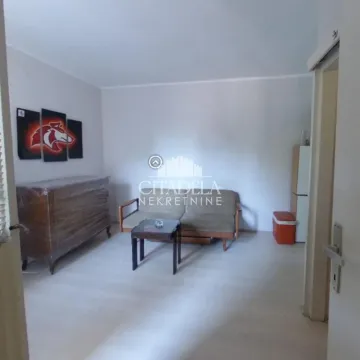 Small living room with a sofa, coffee table, and chest of drawers. - image 3