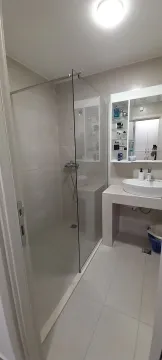 Bright bathroom with a walk-in shower and a modern sink. - image 2
