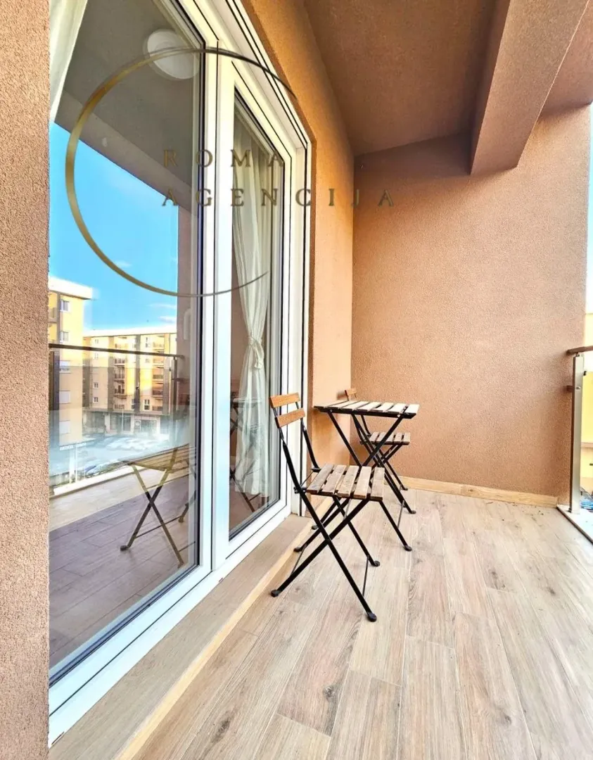 Furnished terrace with a wooden table and chairs.