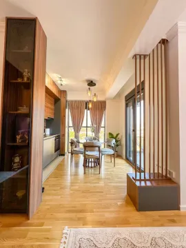Modern kitchen with a dining area and wooden details. - image 3