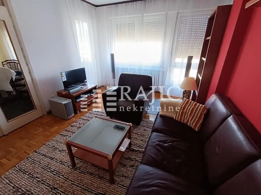 Furnished living room with a sofa, coffee table, and TV.