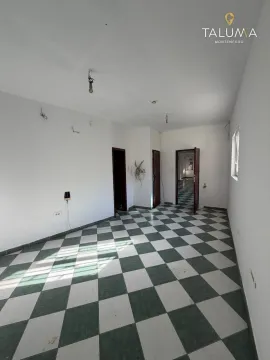 Empty room with checkered floor tiles and several doors. - image 4