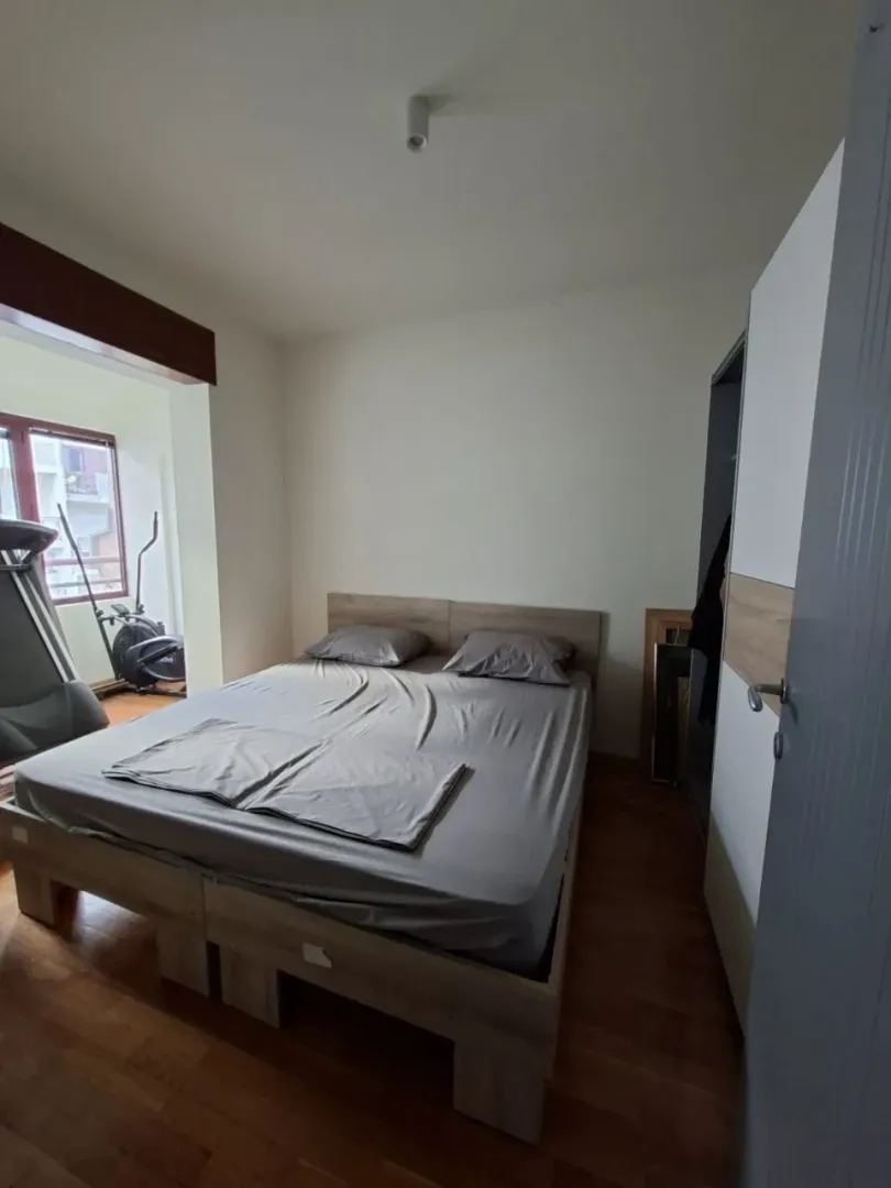 Bedroom with a double bed and a wardrobe.