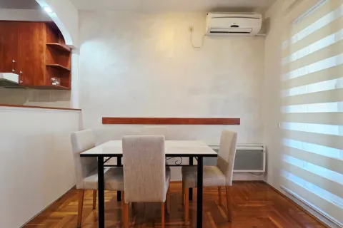 Dining area with a table and four chairs. - image 13