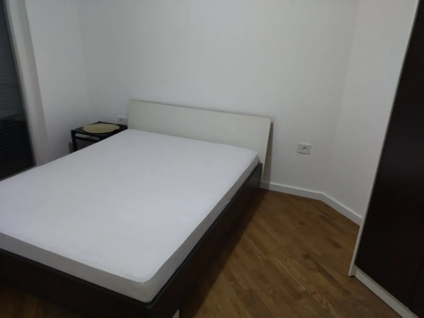 Bedroom with a double bed and wooden flooring.