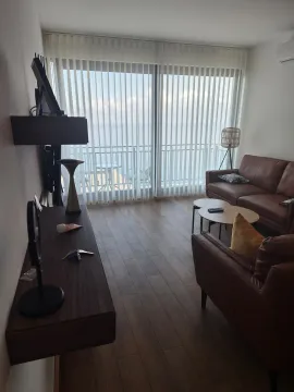 Bright living room with sofa set and a view of the terrace and sea. - image 6
