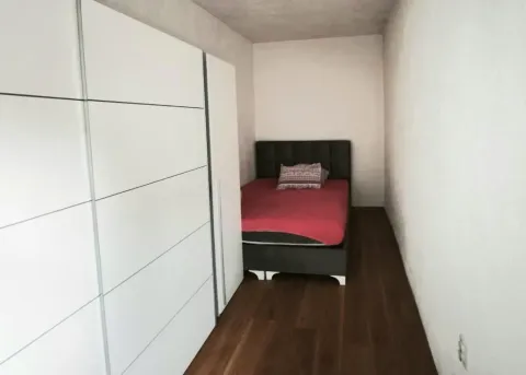 Small bedroom with a bed and a large fitted wardrobe. - image 6