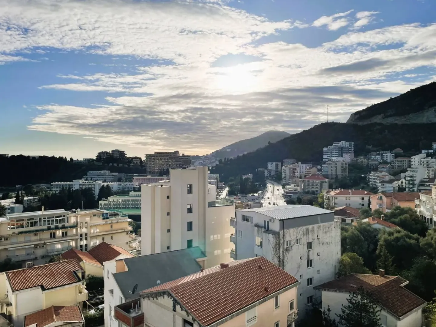 View from the window overlooking the city and hills in the background.
