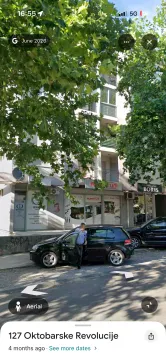 Exterior view of the residential building with commercial spaces on the ground floor. - image 8