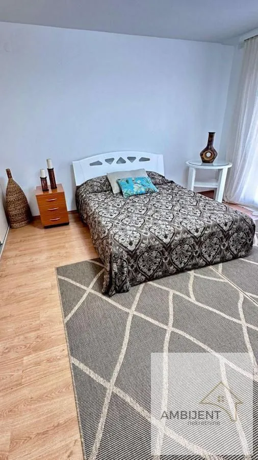 Bedroom with a double bed and a nightstand.