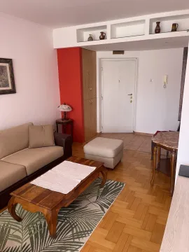 Bright living room featuring a sofa, wooden coffee table, and parquet flooring. - image 2
