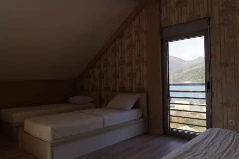 Attic bedroom with three beds and a lake view. - image 6