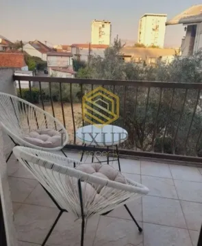 Furnished balcony with seating set and surrounding view. - image 3