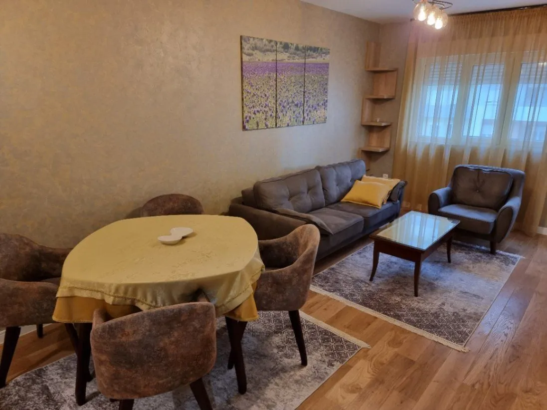 Bright living room with a seating area and a dining table.