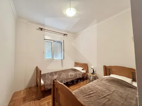 Bedroom with two wooden beds and a window. - image 4
