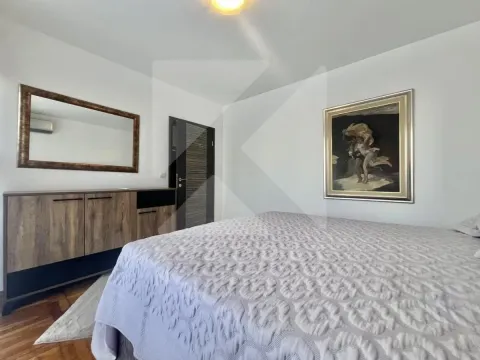 Furnished bedroom with a double bed, chest of drawers, mirror, and artwork on the wall. - image 6