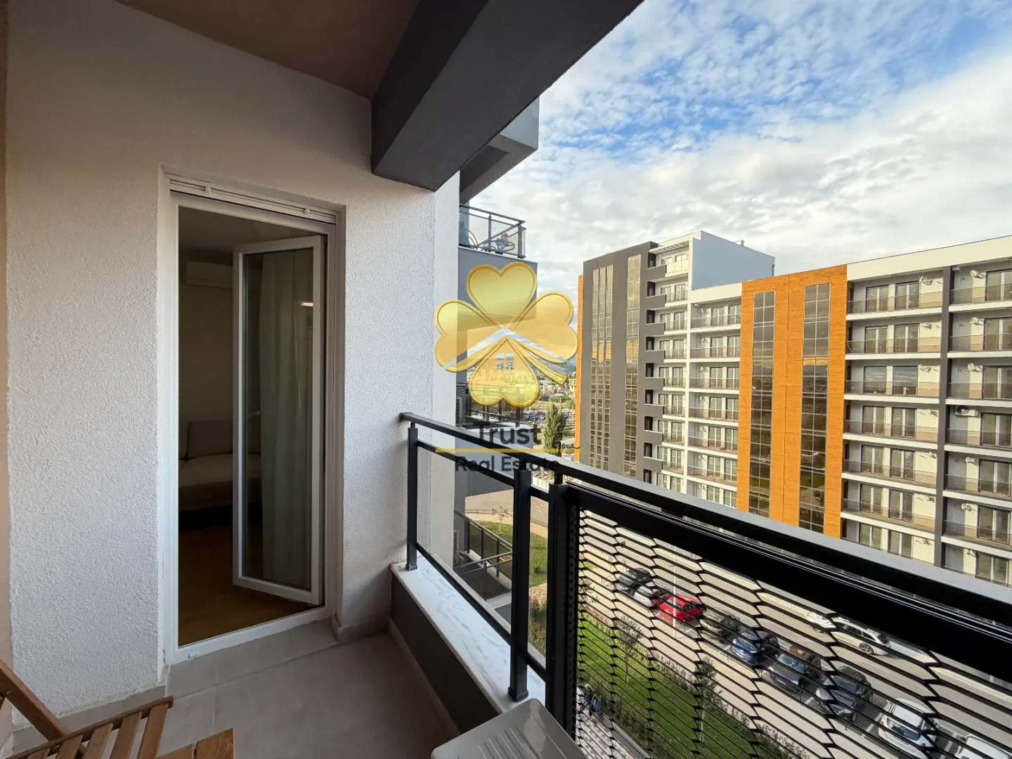 Balcony with a railing and a view of surrounding buildings.