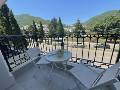 Furnished balcony with a table, chairs, and a view of the surroundings. - image 7