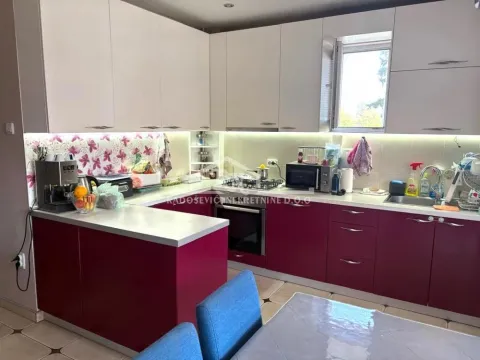 Kitchen with upper and lower cabinets and a counter. - image 13