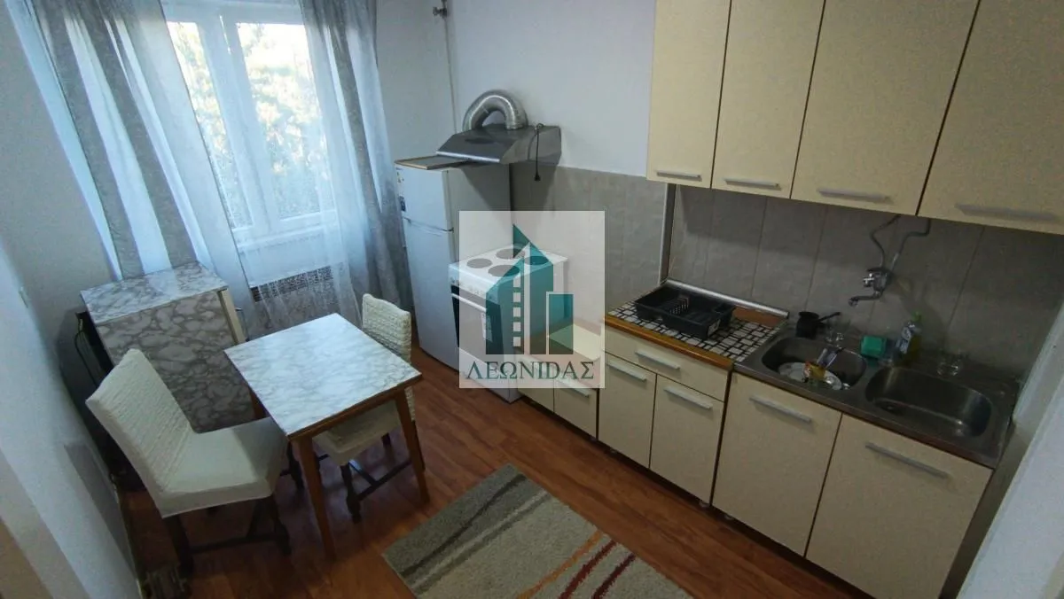 Small kitchen with a dining table and chairs.