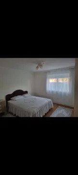 A bright bedroom with a double bed and a window. - image 9