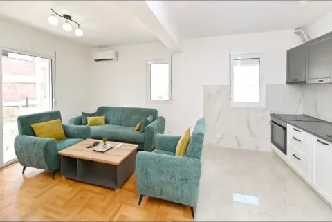 Living room with a sofa set connected to the kitchen in bright tones. - image 3